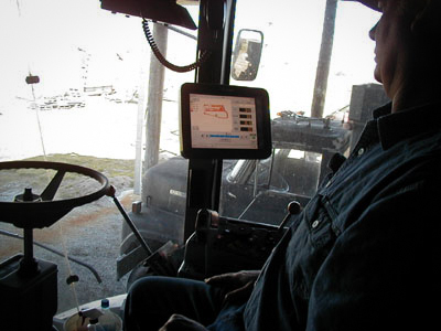 Participating farmer with a yield monitor installed in his combine.