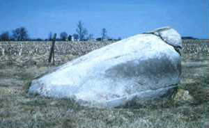 Photo showing a large rock, known to geologists as a glacial erratic, in a field on the Tipton Till Plain of central Indiana.